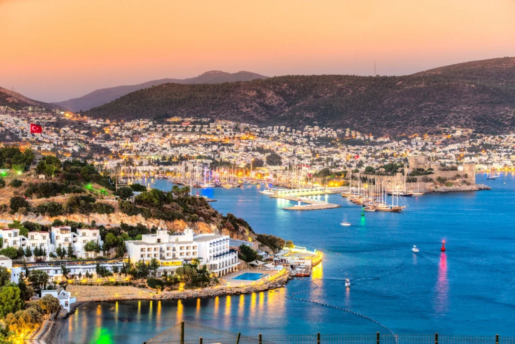 Luxury yacht cruising along Turkey’s stunning coastline with turquoise waters, ancient ruins, and a picturesque marina