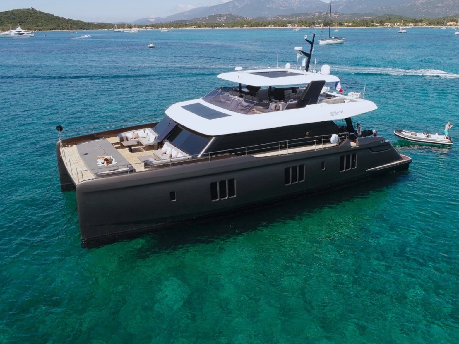 Motor Yacht Seiya, a sleek catamaran cruising on clear blue waters.