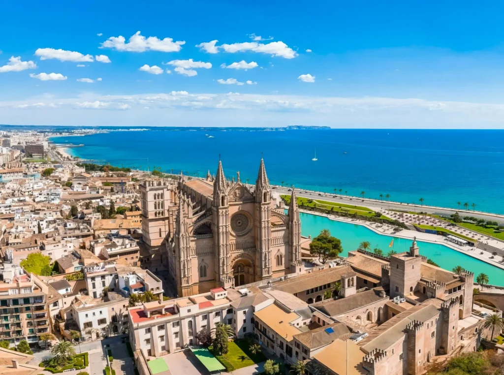 Luxury yacht cruising near Mallorca, Spain, with crystal-clear Mediterranean waters, scenic coastal views, and a vibrant marina