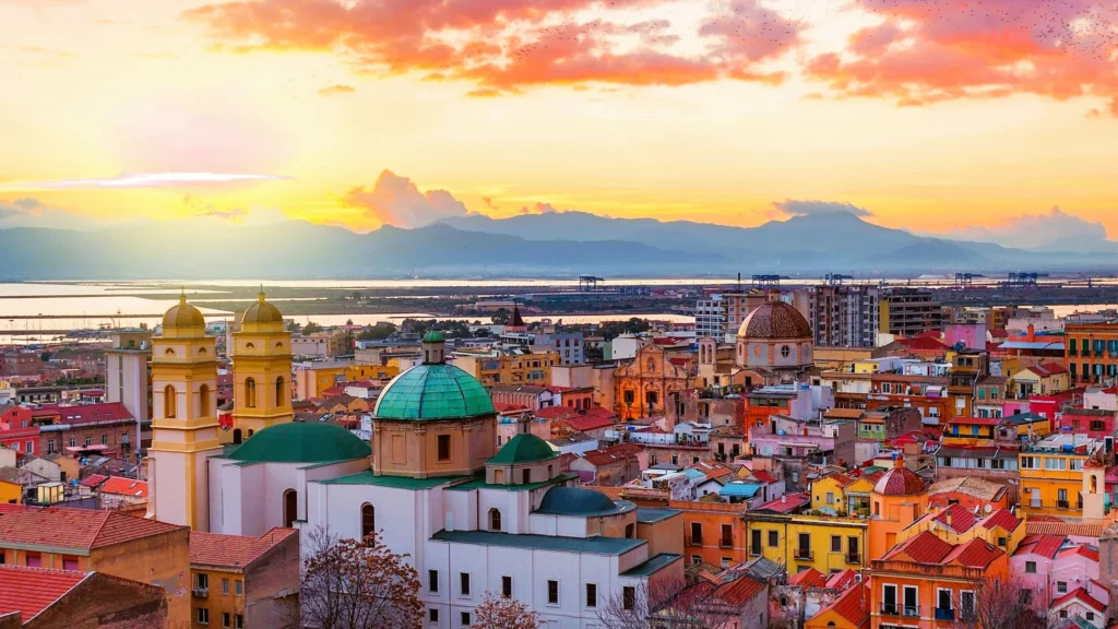 Luxury yacht cruising near Cagliari, Sardinia, Italy, with sparkling blue waters, historic architecture, and scenic coastal landscapes.