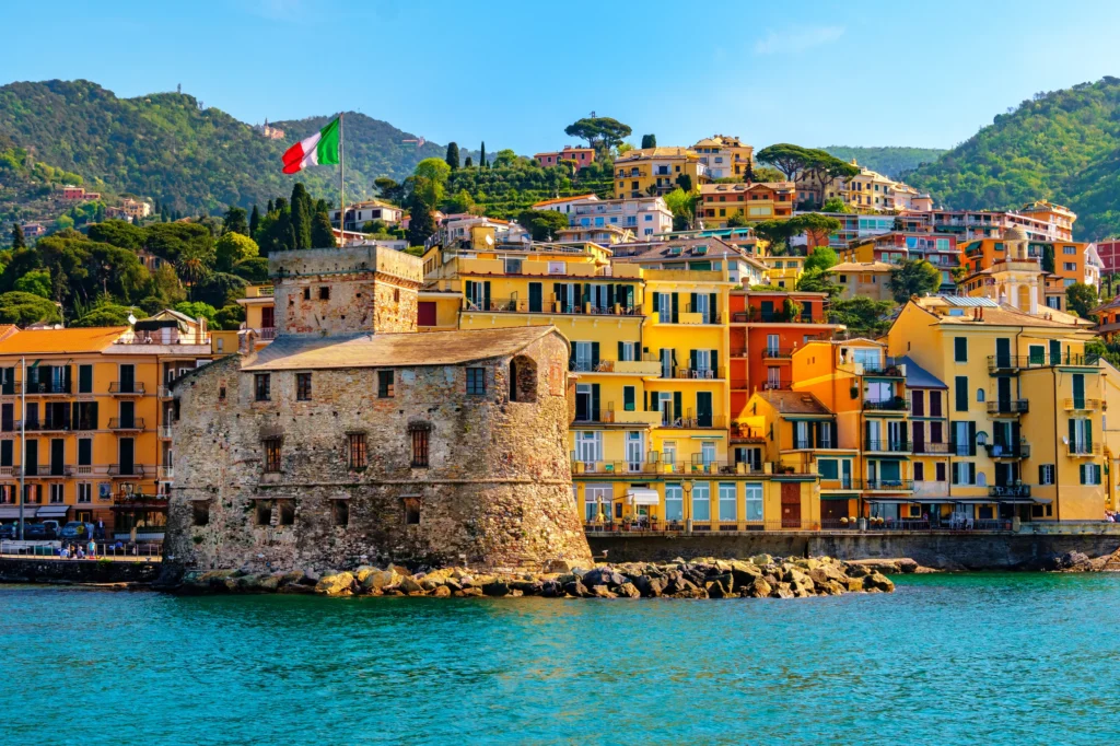 Luxury yacht near La Spezia, Italy, cruising along the Italian Riviera with scenic coastal cliffs, pastel villages, and turquoise waters.