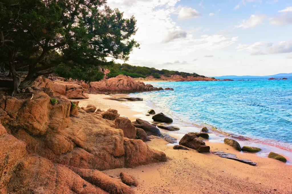 Luxury yacht cruising near Portisco, Sardinia, Italy, with clear turquoise waters, scenic coastline, and a peaceful marina.