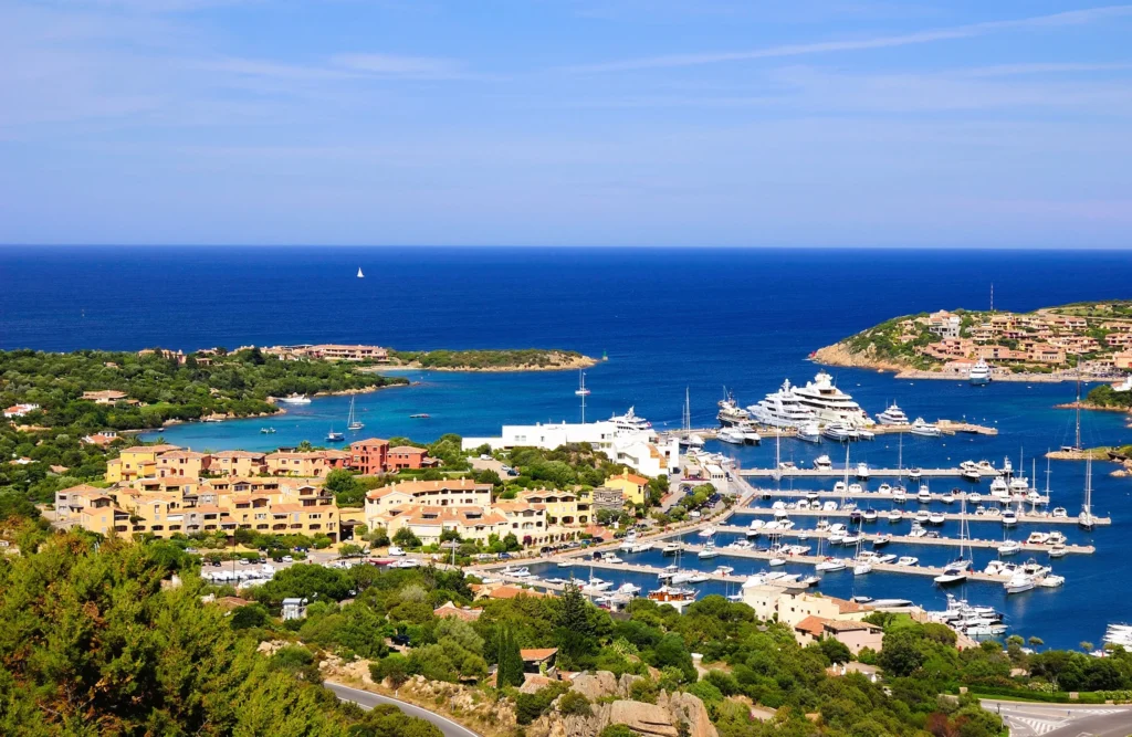 Luxury yacht cruising near Porto Cervo, Sardinia, Italy, with turquoise waters, glamorous marinas, and stunning Mediterranean scenery.