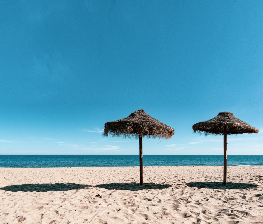 Luxury yacht cruising near Fuengirola, Spain, with crystal-clear Mediterranean waters, vibrant marina, and scenic coastal views