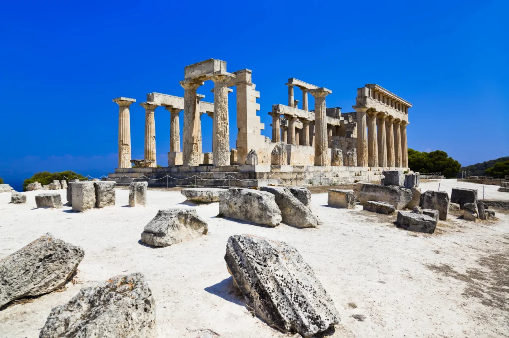 Luxury yacht cruising near Aegina in the Saronic Gulf, Greece, with scenic blue waters, ancient temples, and picturesque coastal views