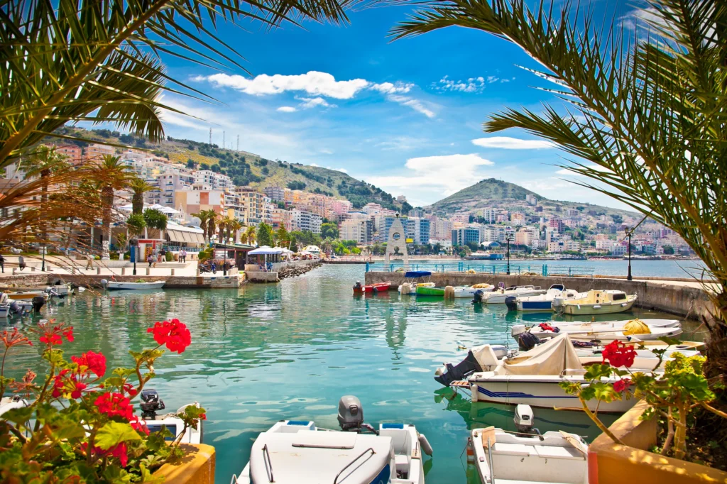 Luxury yacht cruising along Albania’s pristine coastline, with sparkling blue waters, rugged mountains, and picturesque beaches