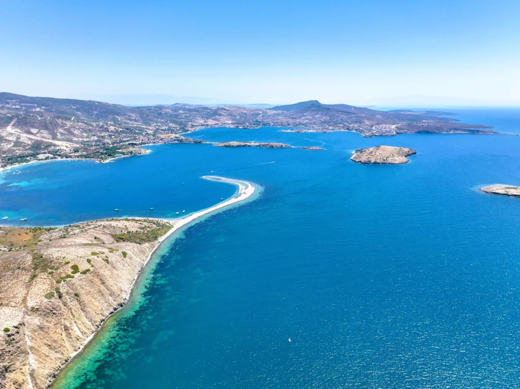 Luxury yacht cruising near Bodrum, Turkey, with pristine turquoise waters, scenic coastal views, and a vibrant marina backdrop.