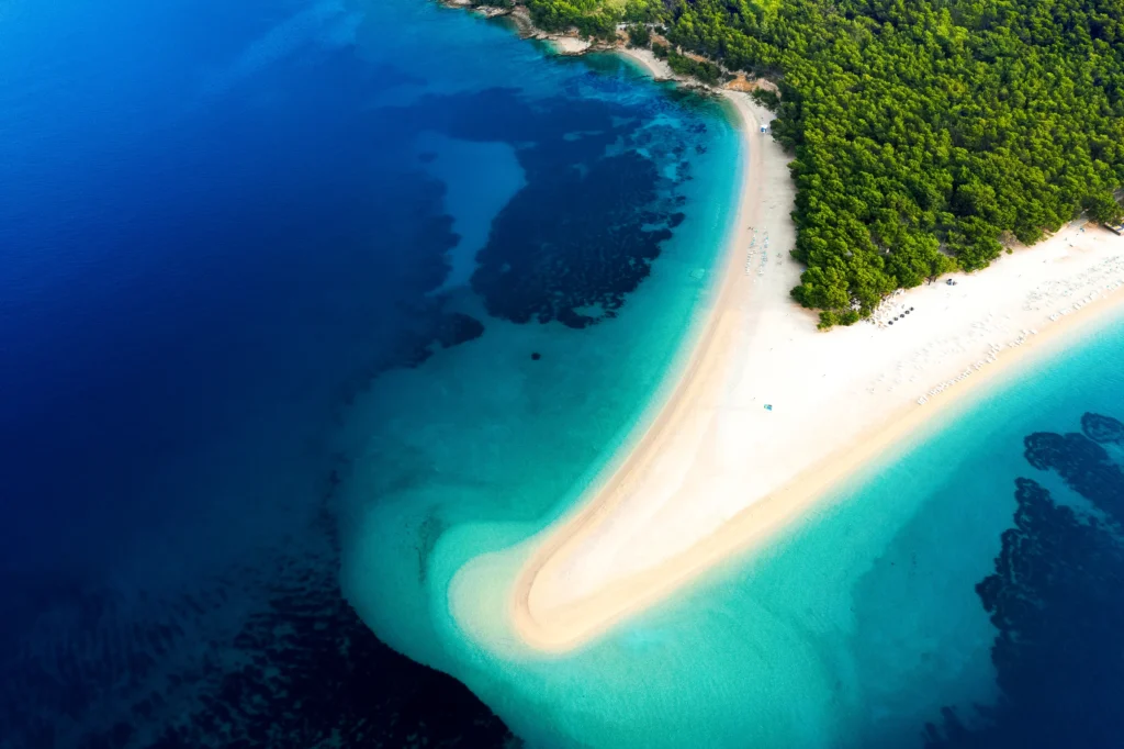 Luxury yacht cruising near Brač, Croatia, with clear Adriatic waters, charming coastal views, and historic island scenery.