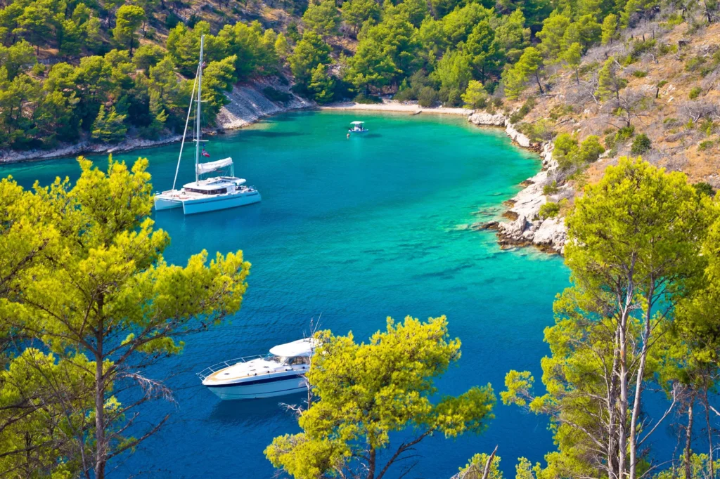 Luxury yacht cruising near Brač, Croatia, with clear Adriatic waters, charming coastal views, and historic island scenery.