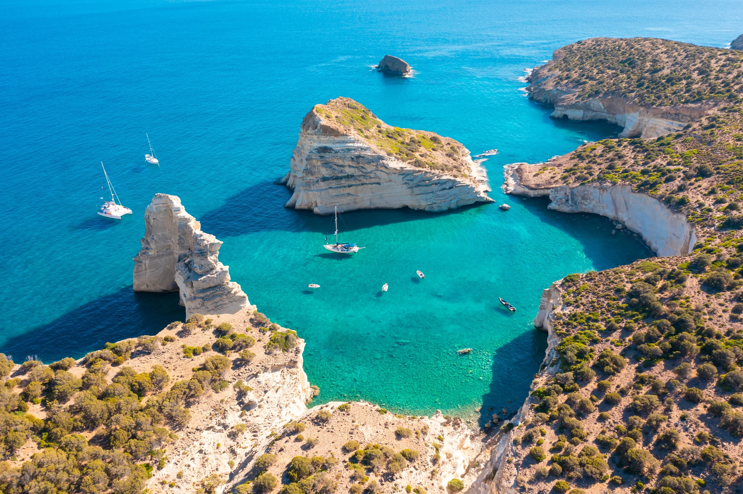 Luxury yacht sailing among the Cyclades Islands, Greece, with iconic whitewashed villages, azure waters, and breathtaking island vistas