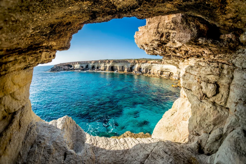 Luxury yacht cruising near Cyprus, featuring clear Mediterranean waters, historic coastal sites, and a vibrant marina