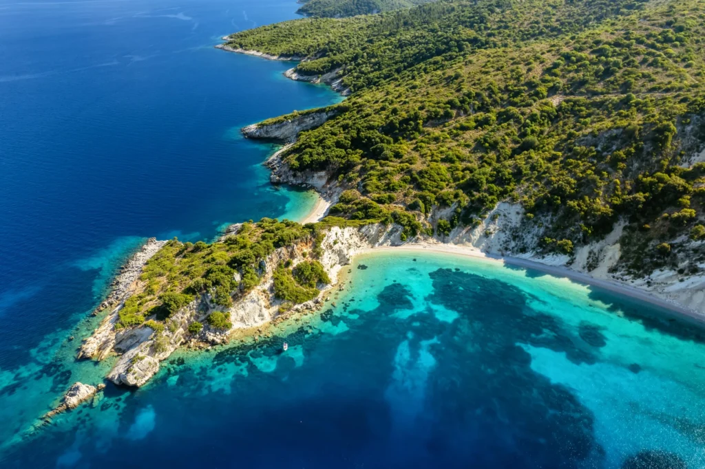 Luxury yacht cruising near Ithaca, Greece, with pristine Ionian Sea waters, rugged coastlines, and lush island scenery.