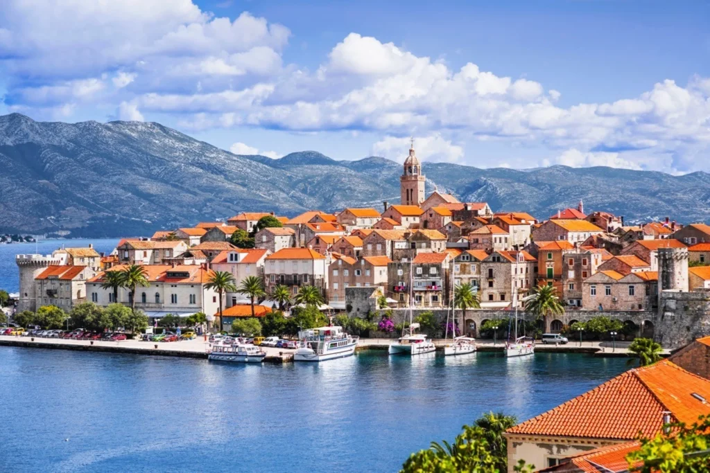 Luxury yacht cruising near Korčula, Croatia, with turquoise Adriatic waters, historic coastal charm, and scenic island vistas.