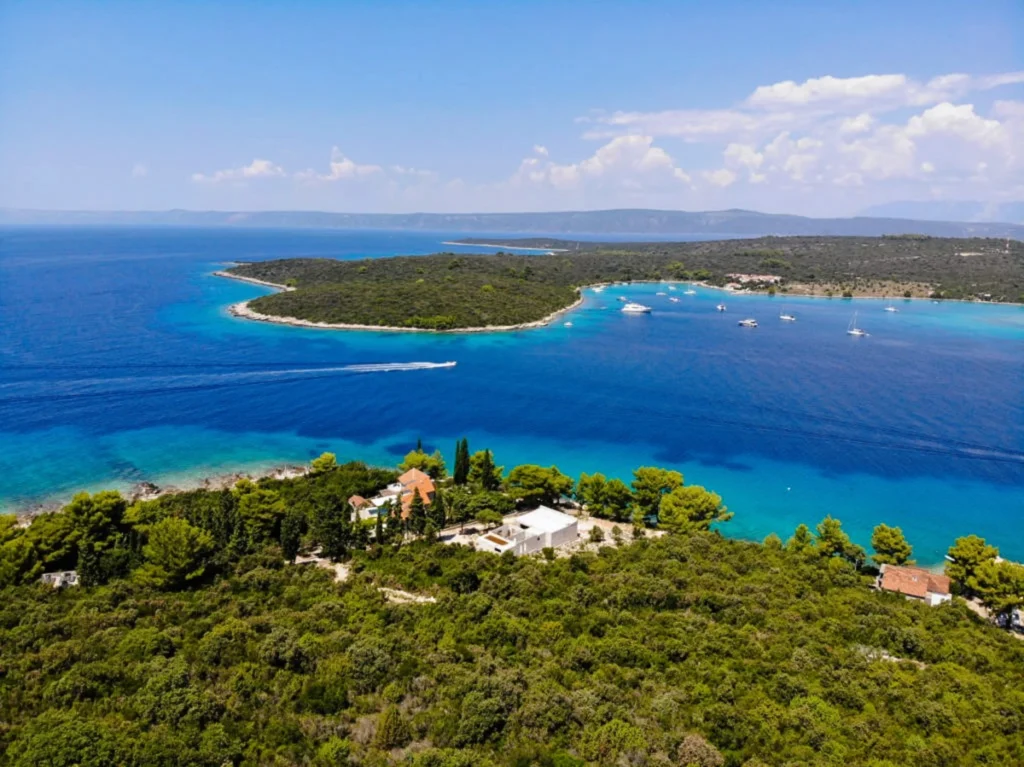 Luxury yacht cruising near Korčula, Croatia, with turquoise Adriatic waters, historic coastal charm, and scenic island vistas.