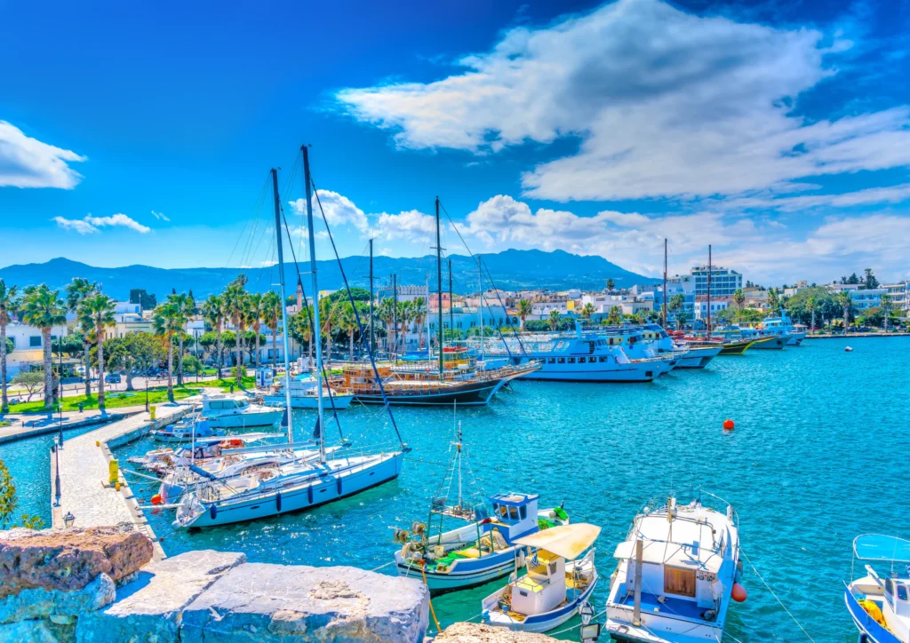 Luxury yacht cruising near Kos in the Dodecanese Islands, Greece, with azure waters, ancient ruins, and a scenic coastline.