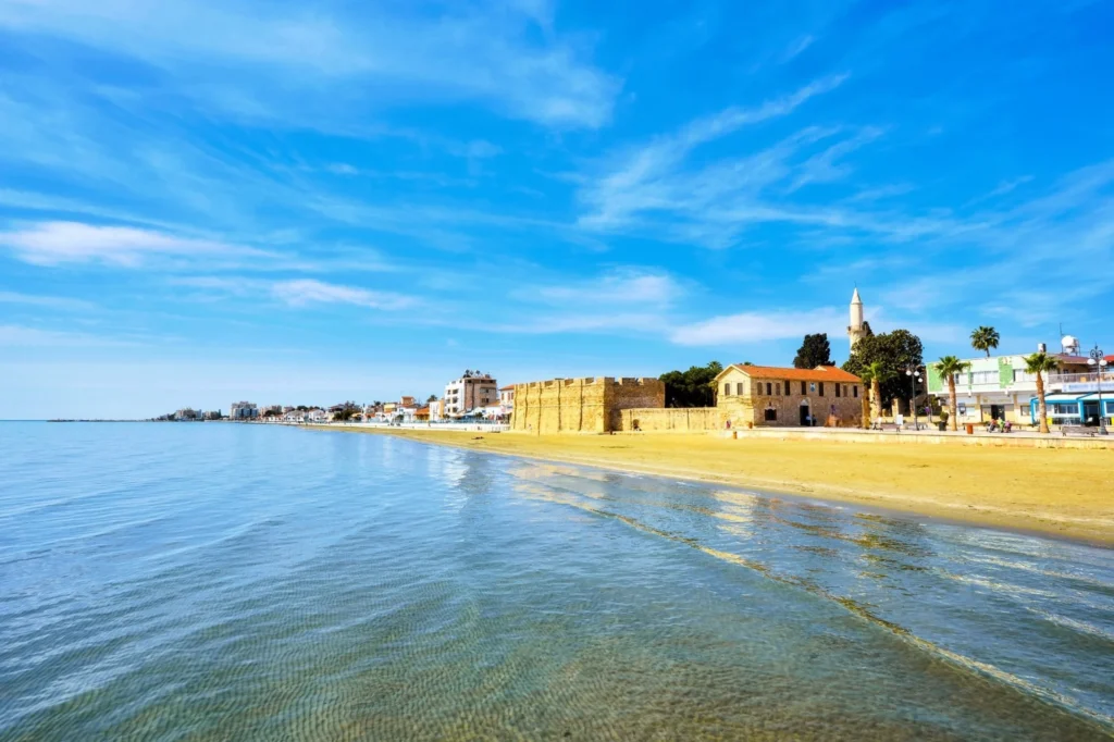 Luxury yacht cruising near Larnaca, Cyprus, with sparkling Mediterranean waters, scenic coastal views, and a vibrant port atmosphere.
