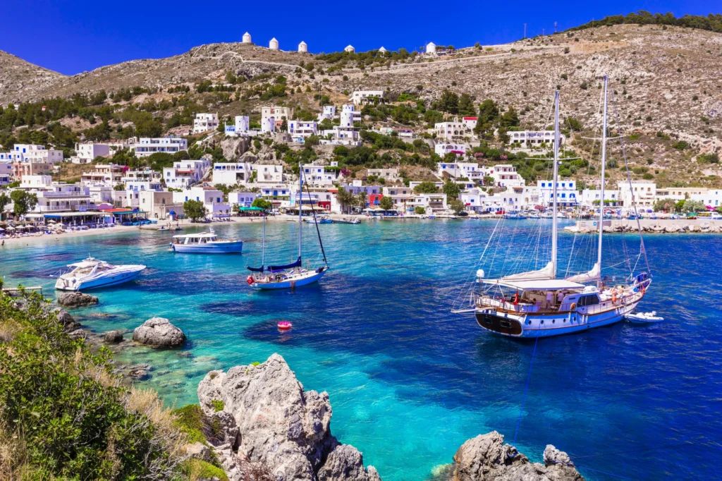 Luxury yacht cruising near Leros in the Dodecanese Islands, Greece, with clear Mediterranean waters, charming coastal villages, and lush landscapes.