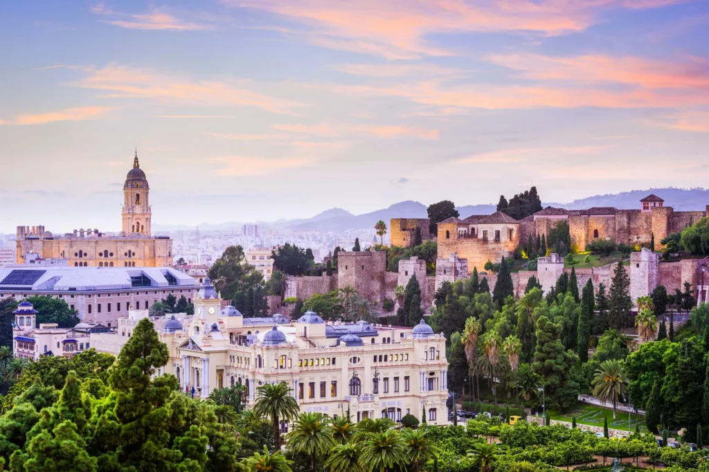 Luxury yacht cruising off the coast of Malaga, Spain, with sparkling Mediterranean waters, picturesque coastal views, and a bustling marina