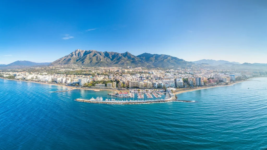 Luxury yacht cruising near Marbella, Costa del Sol, with clear Mediterranean waters, chic marinas, and a sun-drenched coastline