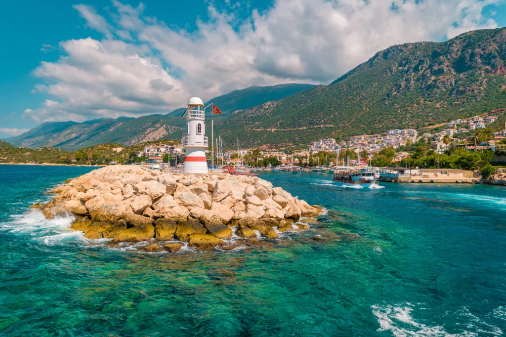 Luxury yacht cruising near Marmaris, Turkey, with sparkling turquoise waters, rugged coastline, and a vibrant marina.