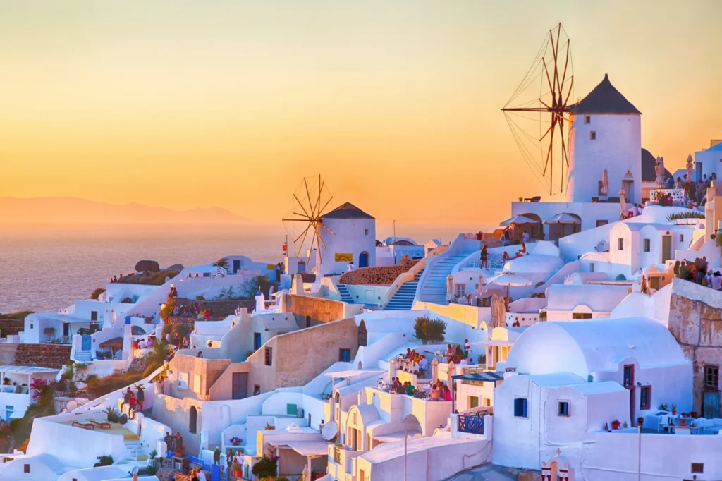 Luxury yacht cruising near Mykonos in the Cyclades Islands, Greece, with turquoise waters, iconic windmills, and vibrant coastal scenery