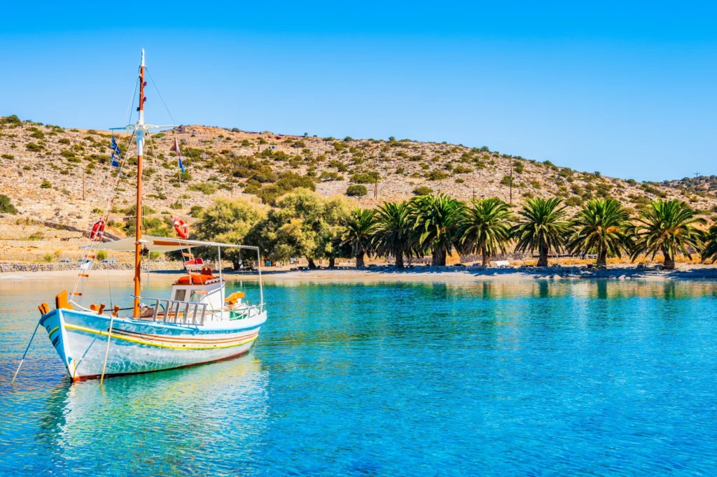 Luxury yacht cruising near Naxos in the Cyclades Islands, Greece, with pristine blue waters, charming coastal landscapes, and ancient ruins in the background
