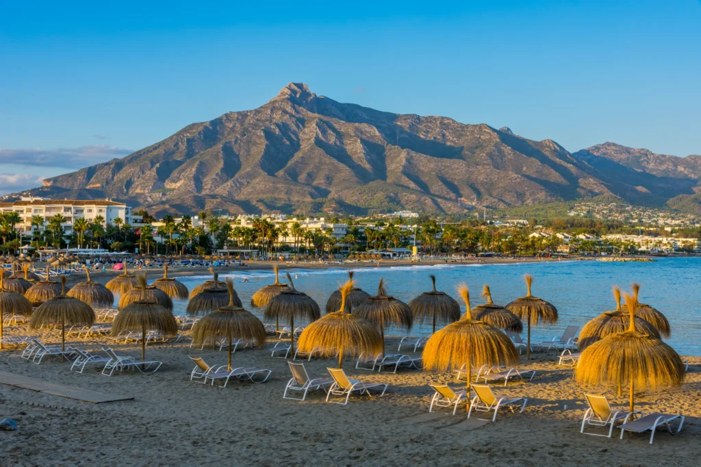 Luxury yacht docked in Puerto Banús, Spain, with vibrant marina views, crystal-clear Mediterranean waters, and upscale coastal scenery