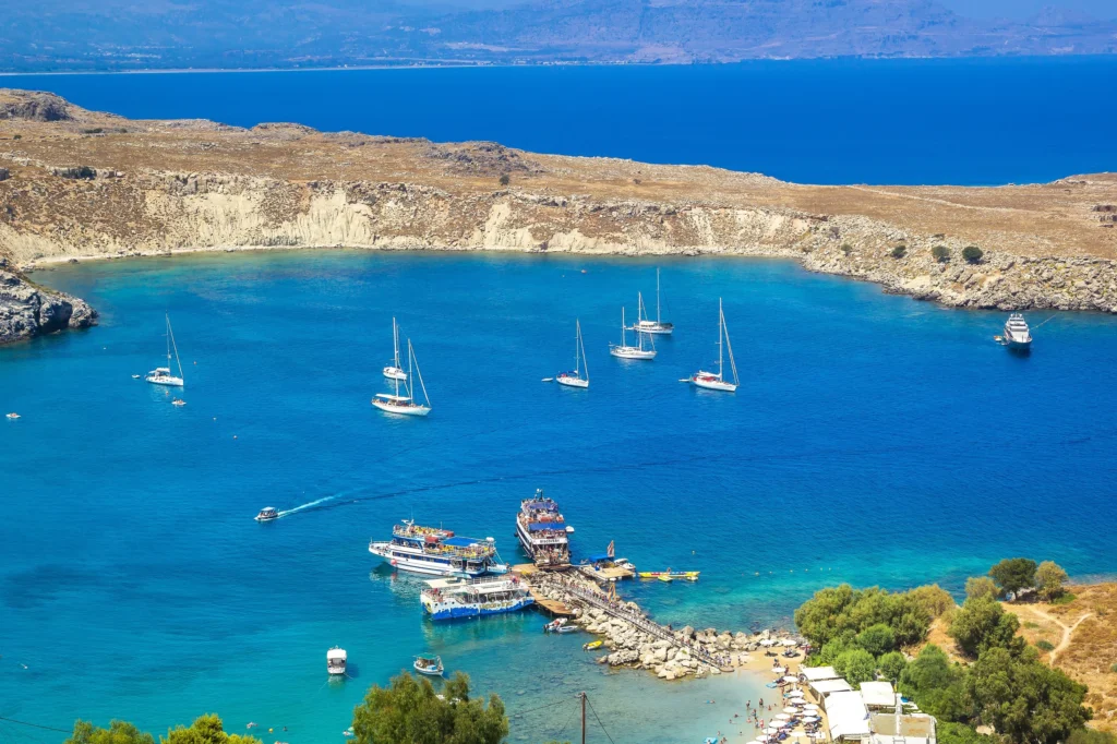Luxury yacht cruising near Rhodos in the Dodecanese Islands, Greece, with ancient ruins, crystal-clear Aegean waters, and scenic coastal views