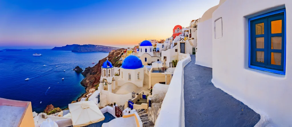 Luxury yacht cruising near Santorini in the Cyclades Islands, Greece, with breathtaking caldera views, whitewashed villages, and sparkling Aegean waters.