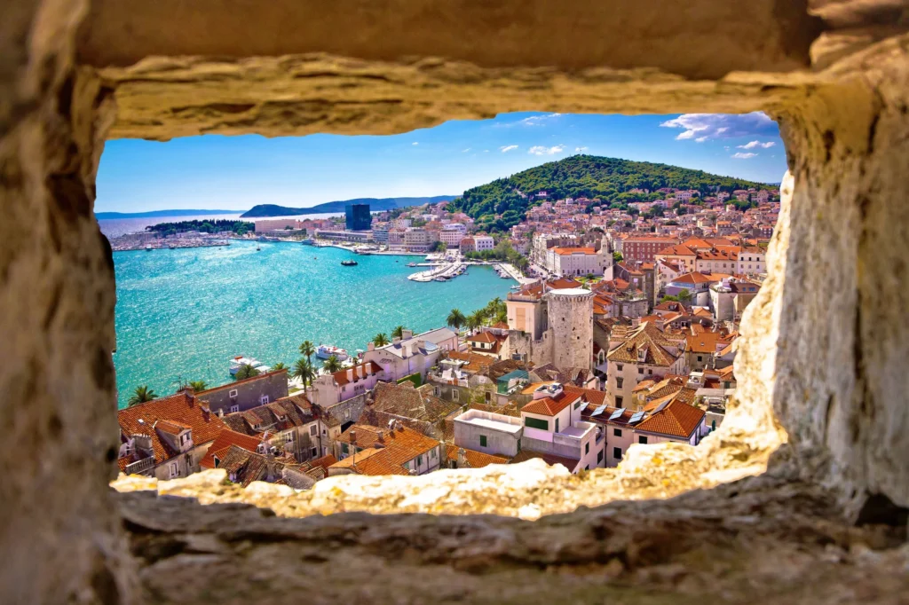 Luxury yacht cruising near Split, Croatia, with crystal-clear Adriatic waters, historic architecture, and scenic coastal views.
