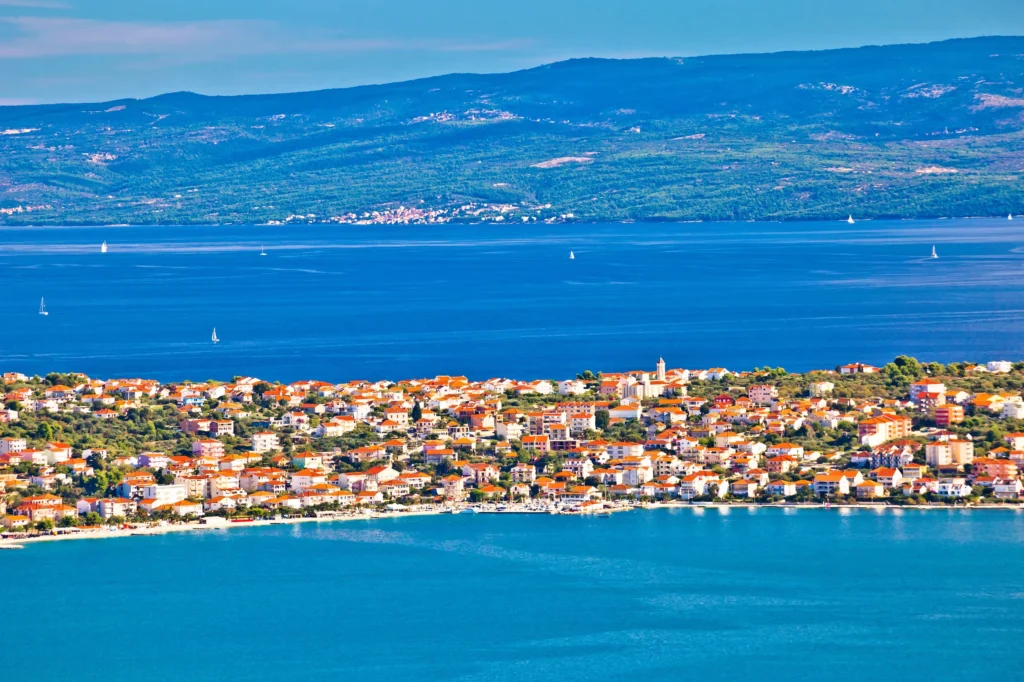 Luxury yacht cruising near Split, Croatia, with crystal-clear Adriatic waters, historic architecture, and scenic coastal views.