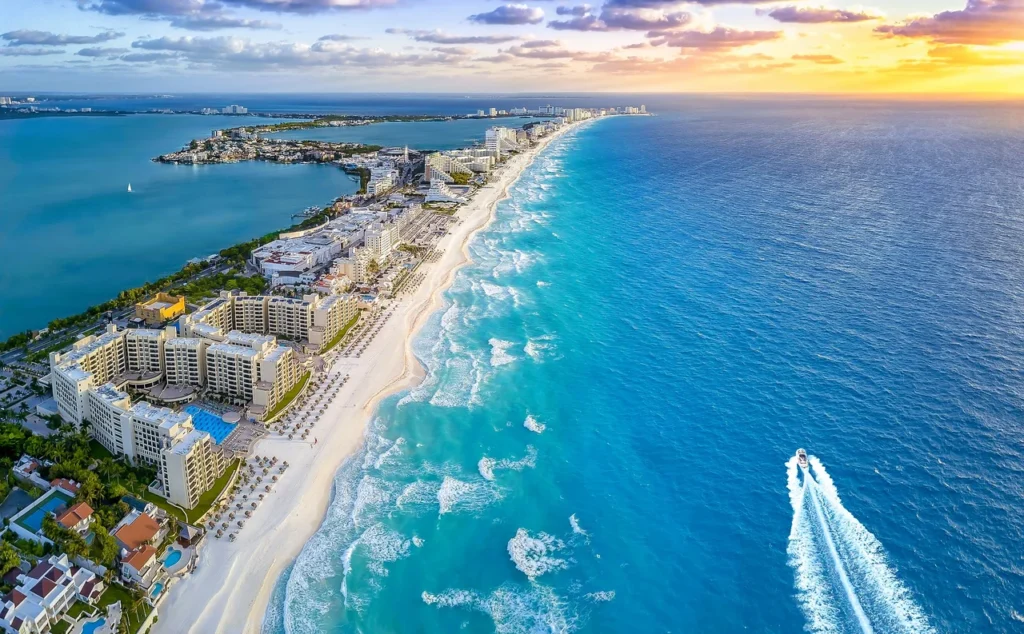 Luxury yacht anchored near the white sandy beaches of Cancun, Mexico, with turquoise waters and palm trees