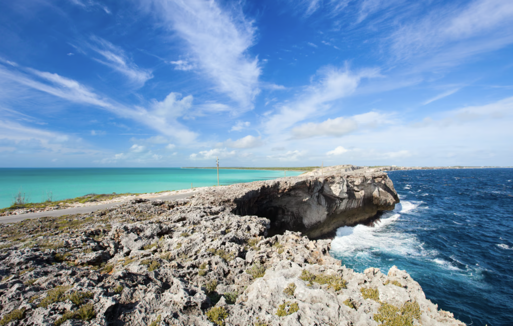 Luxury yacht cruising near Eleuthera in the Bahamas, with crystal-clear waters, pristine beaches, and lush tropical scenery.