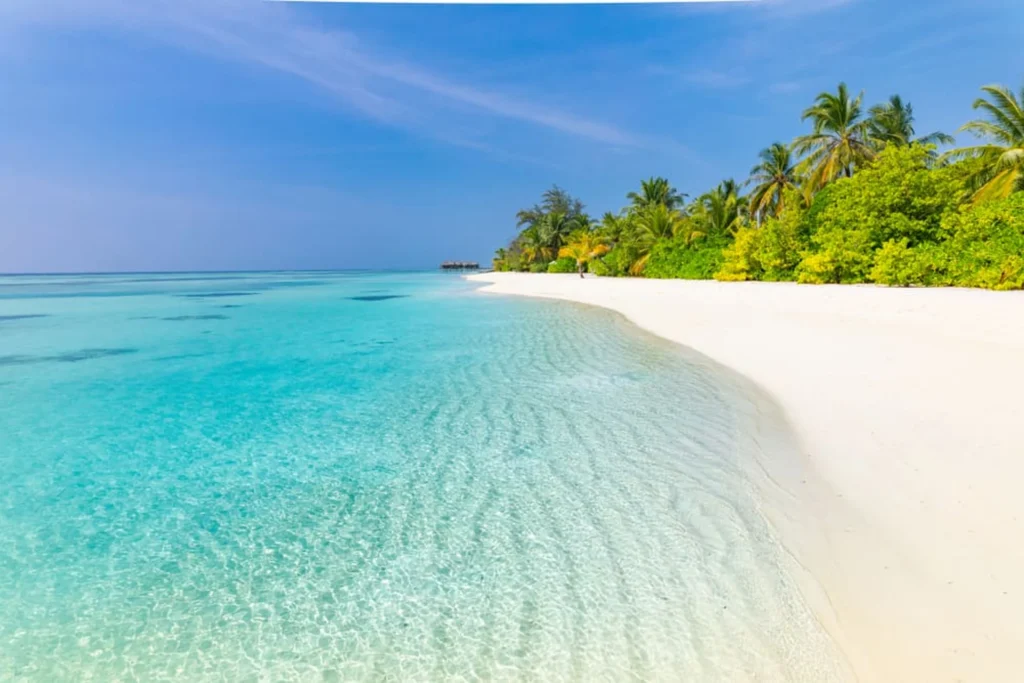 Luxury yacht cruising near the Abaco Islands in the Bahamas, with pristine turquoise waters, lush island scenery, and scenic coastal views.