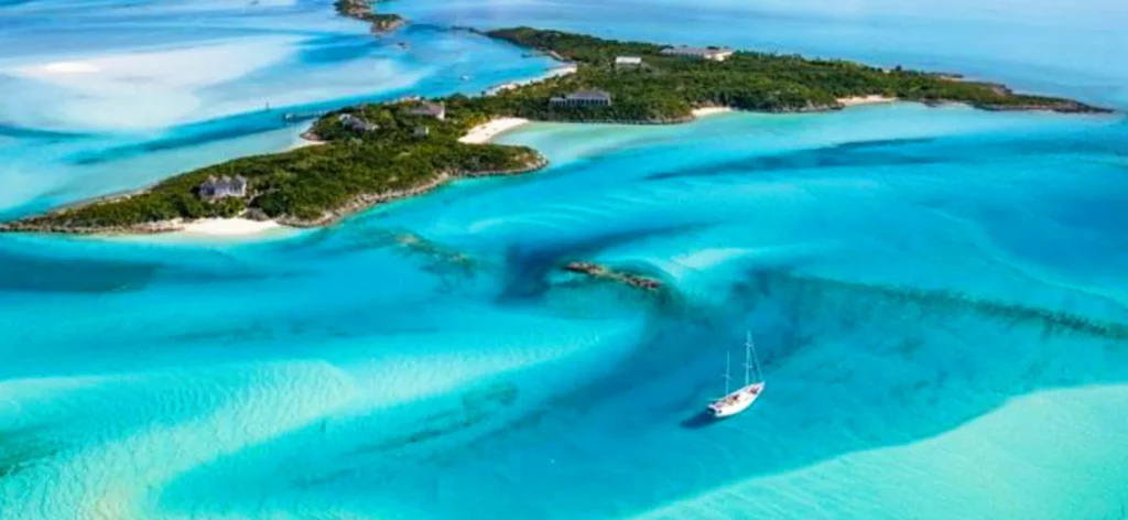 Luxury yacht cruising near Exuma Cays in the Bahamas, with sparkling turquoise waters, scattered idyllic islands, and breathtaking Caribbean views.