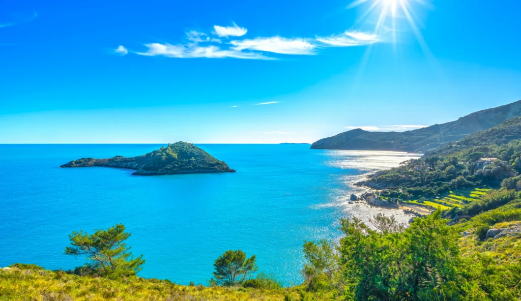 Luxury yacht cruising near Porto Ercole, Tuscany Coast, Italy, with clear blue waters, charming seaside villages, and scenic Mediterranean landscapes.
