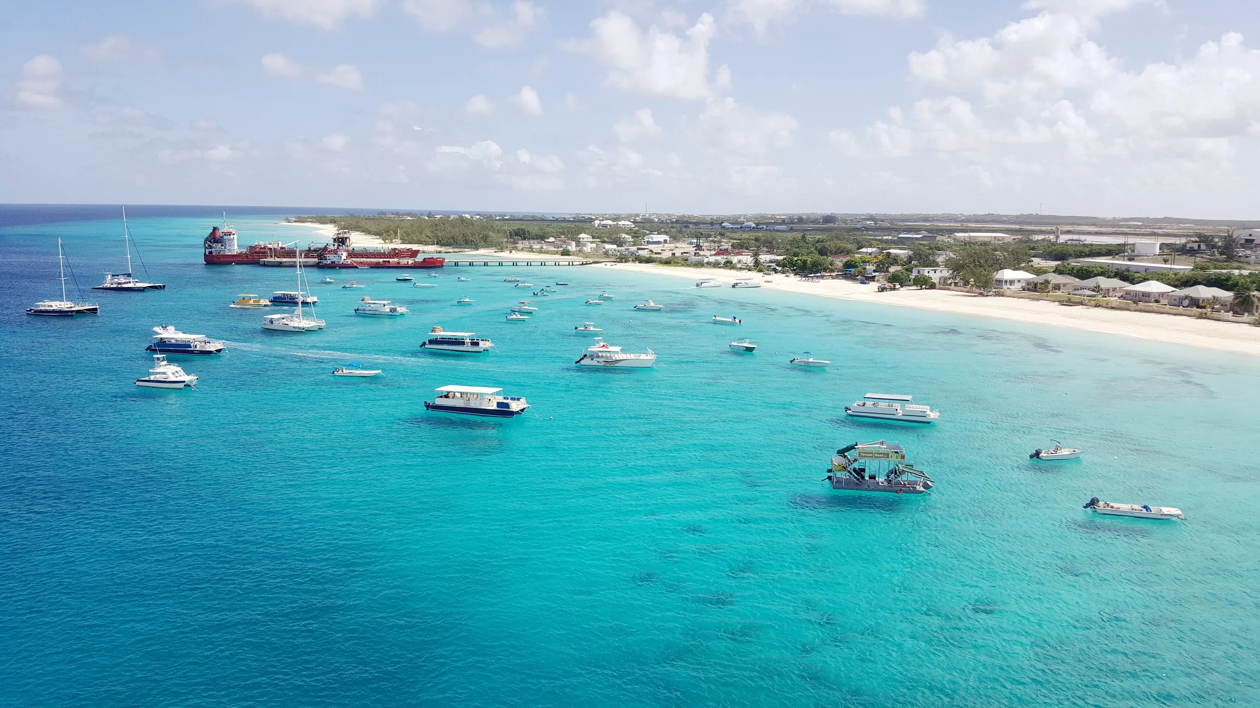 Luxury yacht cruising in the Turks & Caicos, with crystal-clear turquoise waters, pristine white beaches, and vibrant marine life, ideal for exclusive yacht charters.