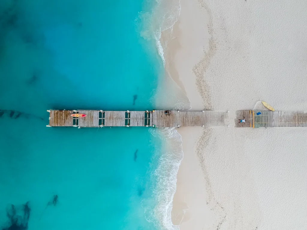 Luxury yacht cruising in the Turks & Caicos, with crystal-clear turquoise waters, pristine white beaches, and vibrant marine life, ideal for exclusive yacht charters.