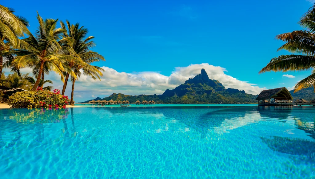 Luxury yacht anchored in Bora Bora, French Polynesia, surrounded by turquoise lagoons, overwater bungalows, and dramatic volcanic peaks.