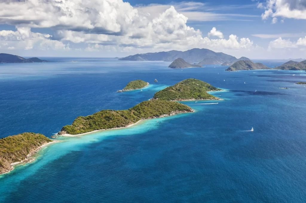 Luxury yacht anchored near St. John in the US Virgin Islands, surrounded by clear turquoise waters, lush hills, and unspoiled beaches.