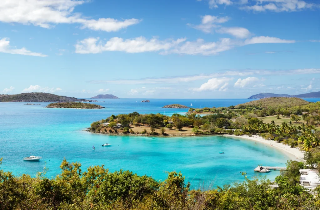 Luxury yacht anchored near St. John in the US Virgin Islands, surrounded by clear turquoise waters, lush hills, and unspoiled beaches.