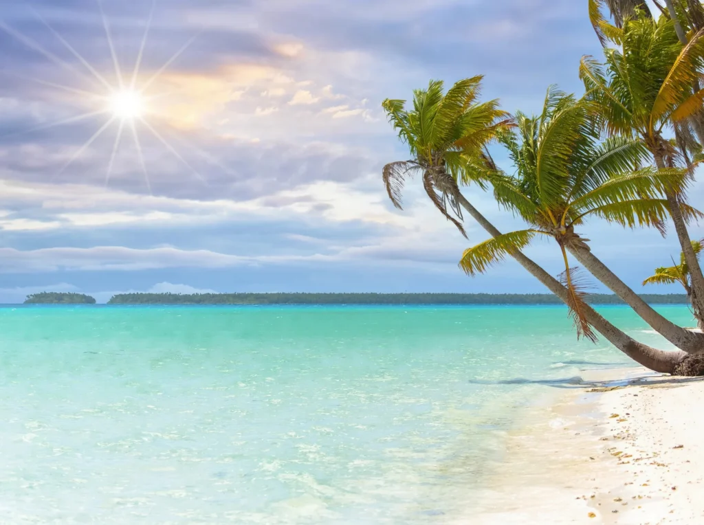 Luxury yacht anchored near Tetiaroa, Society Islands, French Polynesia, with a crystal-clear lagoon, white-sand motus, and untouched tropical scenery.